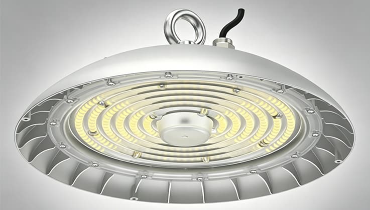 170lm/W Smooth UFO high bay LED light illuminating warehouse aisle with white aluminum housing