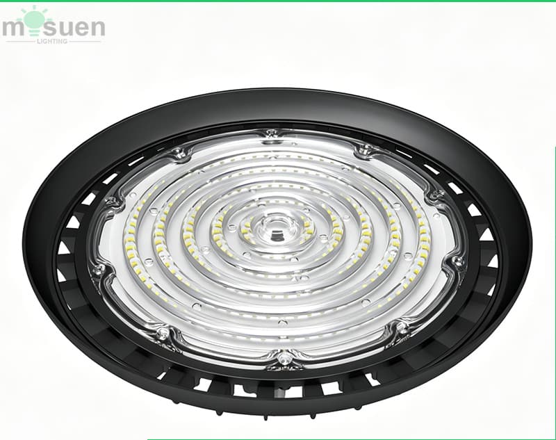 Switchable 3-power UFO high bay light installed in industrial warehouse providing uniform 190lm/W illumination across warehouse floor with stacked inventory and forklift operations